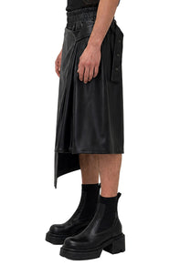 VEGAN LEATHER ASYMMETRIC PLEATED SHORTS